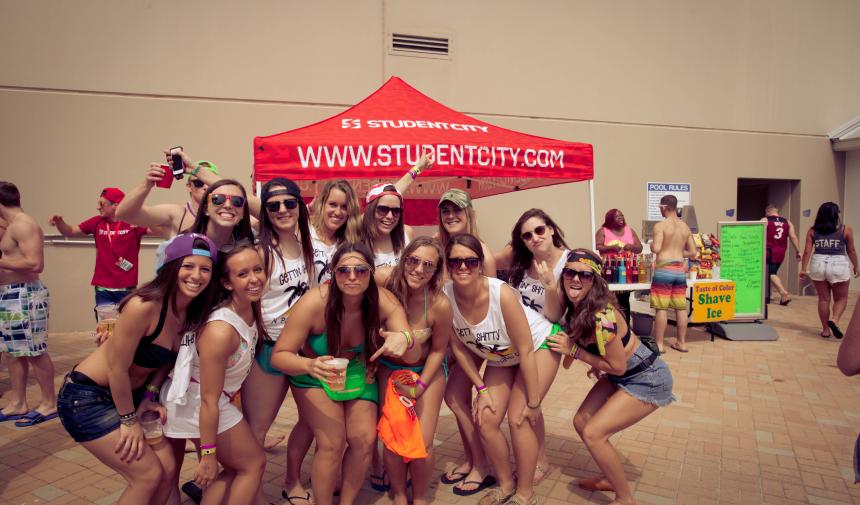 Group of spring breakers standing outside of the StudentCity tent